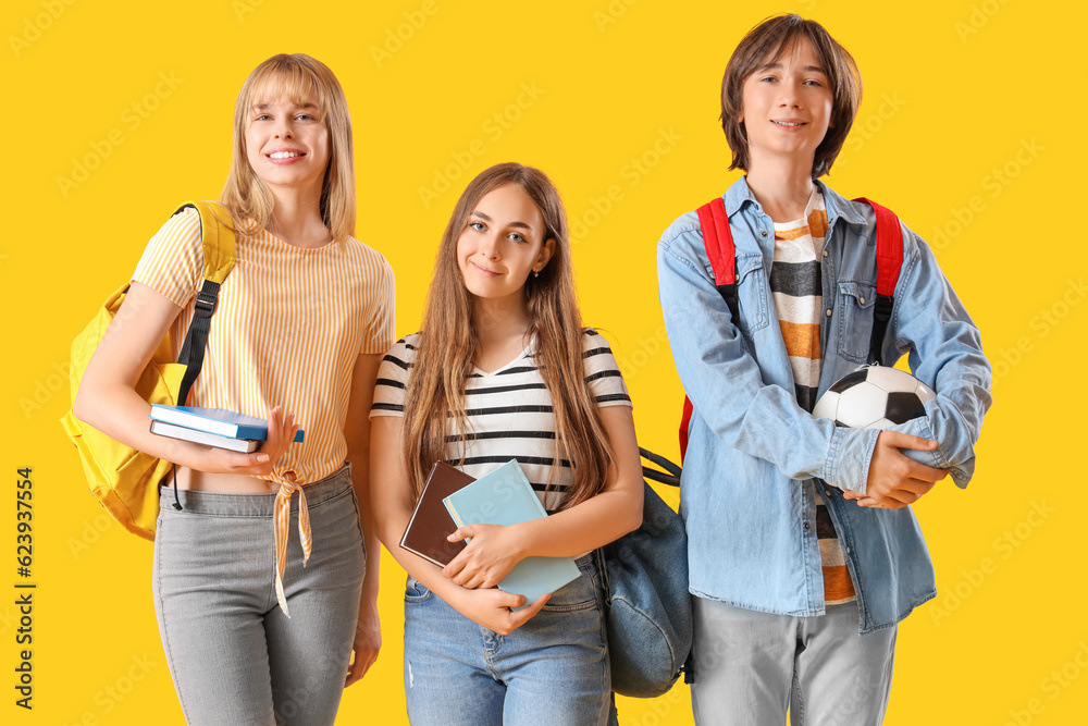 Teenage students on yellow background