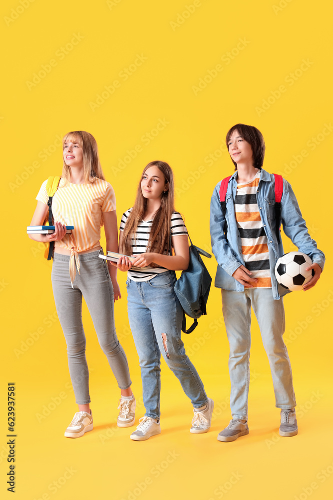 Teenage students on yellow background