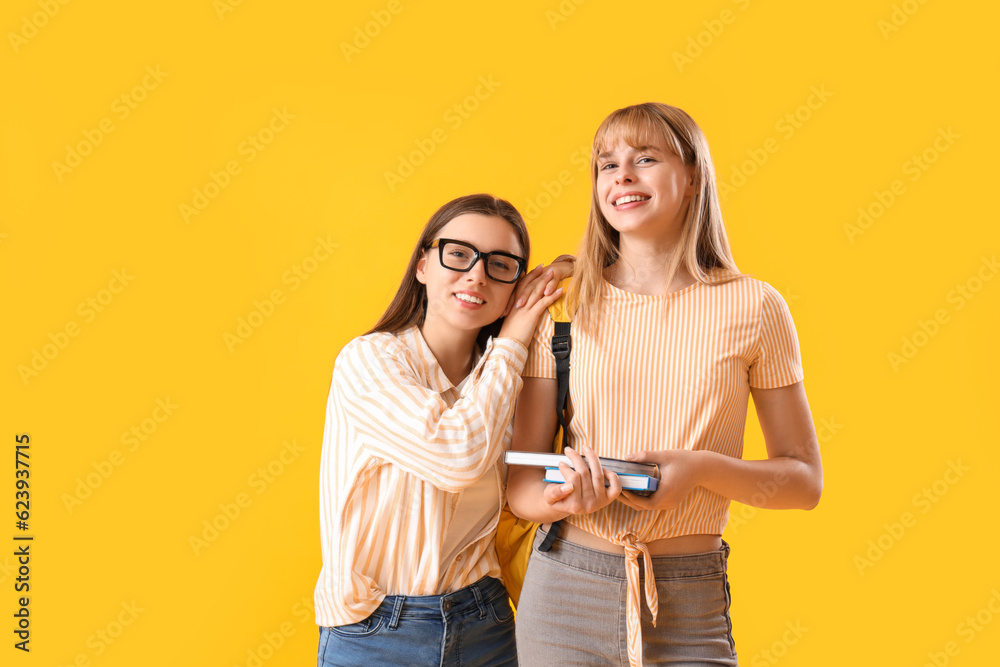 Female students on yellow background