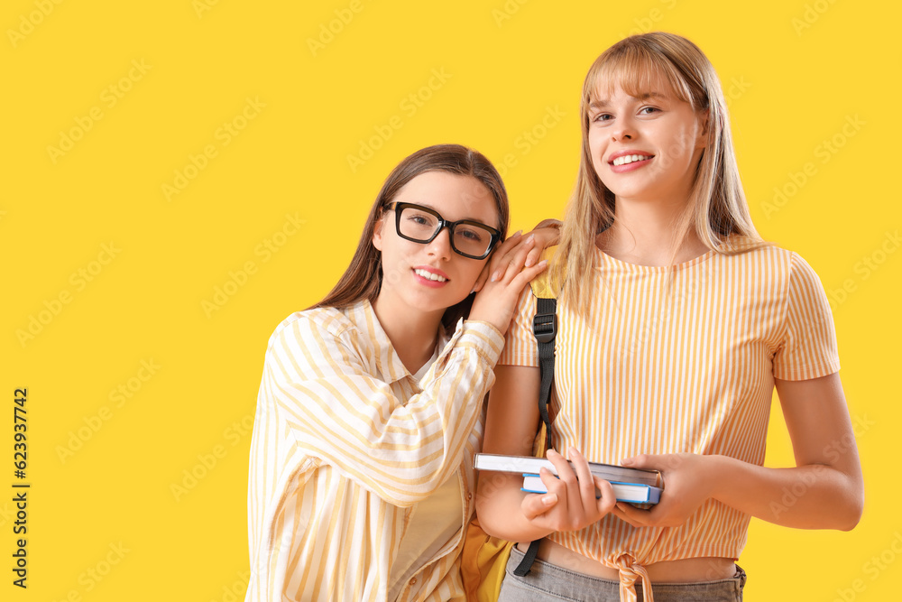 Female students on yellow background