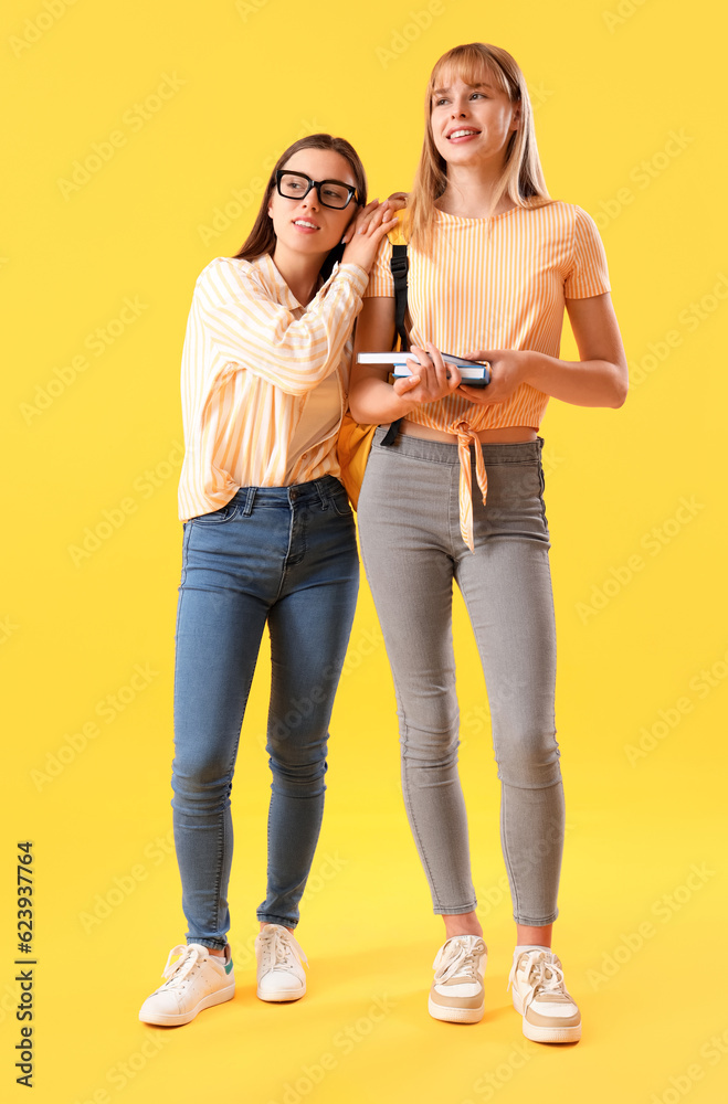 Female students on yellow background