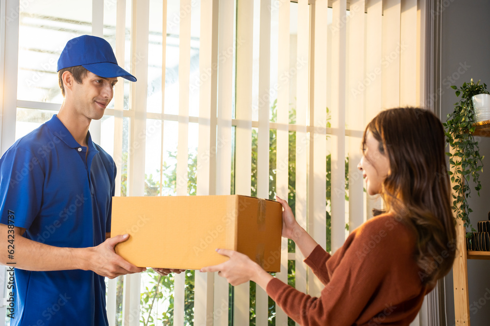 Caucasian young woman receive a box form deliverly man in store house. 