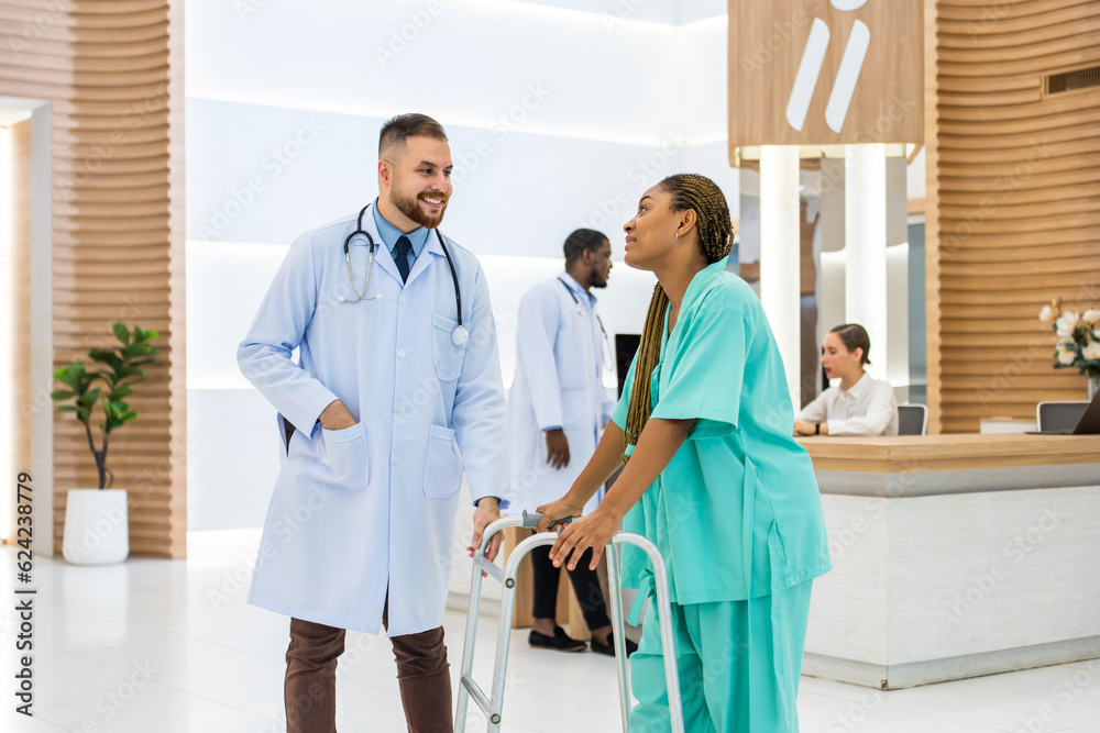 Caucasian doctors support patient walk through the hallway in hospital. 