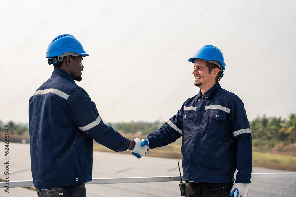 Young engineer making handshake, work with photovoltaic panel system. 