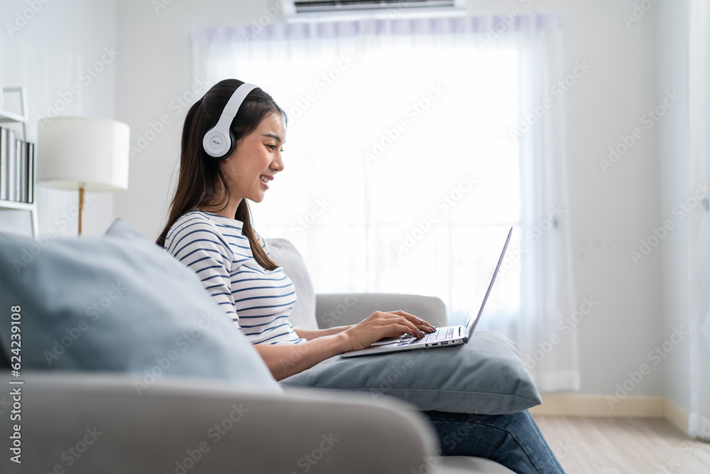 Asian beautiful business woman working and listen to music at home. 