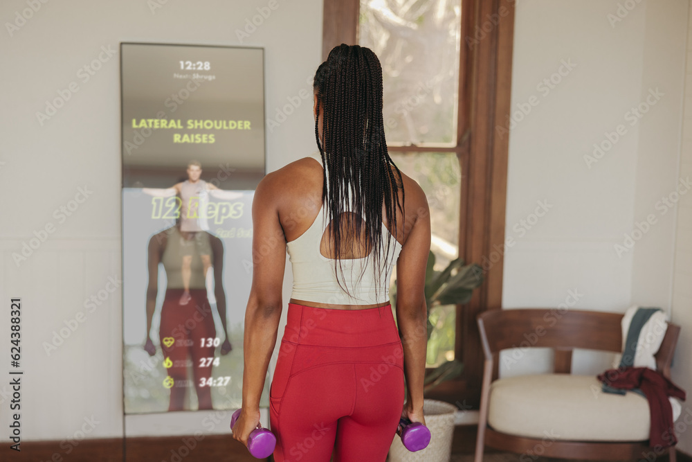 Smart fitness mirror: Woman doing weight training with virtual instructor