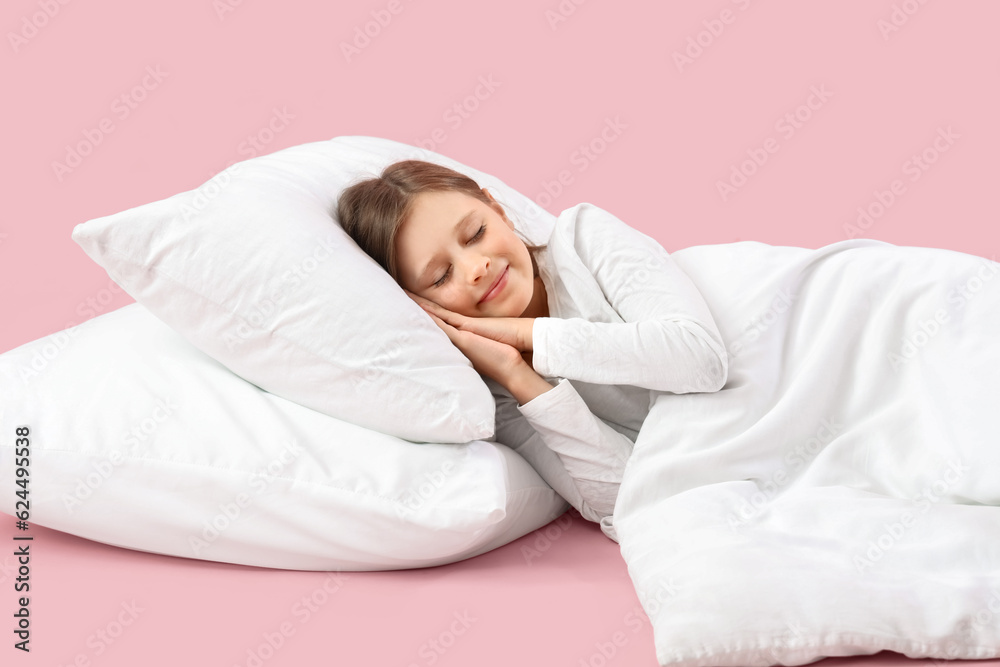 Sleeping little girl on pink background