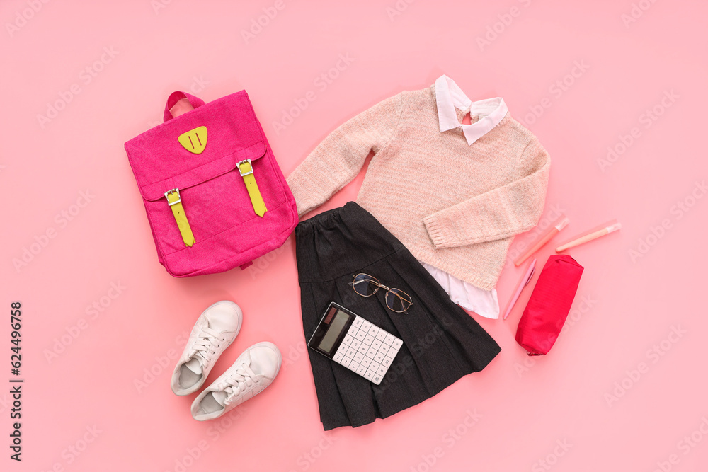 Composition with stylish school uniform, backpack, eyeglasses and stationery on pink background