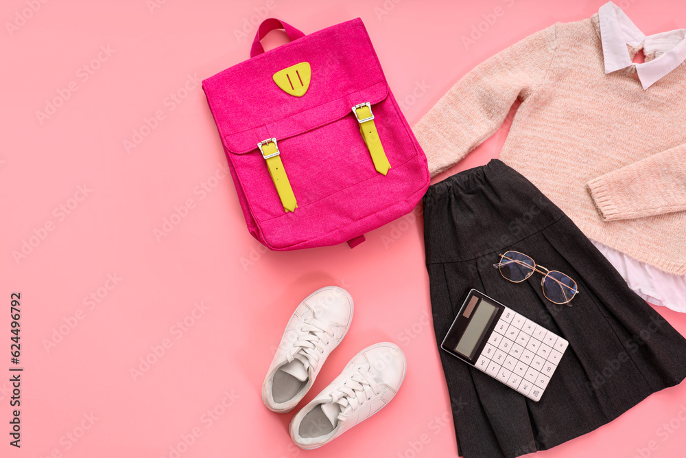 Composition with stylish school uniform, backpack, eyeglasses and stationery on pink background