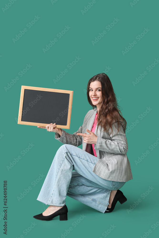 Female teacher with chalkboard on green background