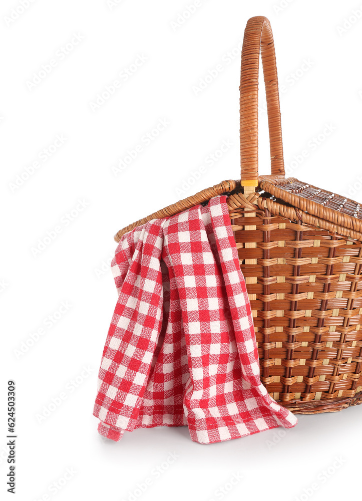 Wicker picnic basket with red checkered napkin on white background, closeup