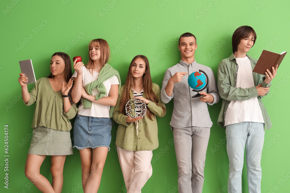 Group of teenage students on green background