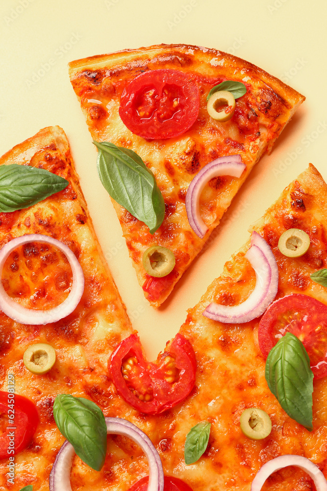 Tasty pizza with olives, tomatoes and basil on beige background