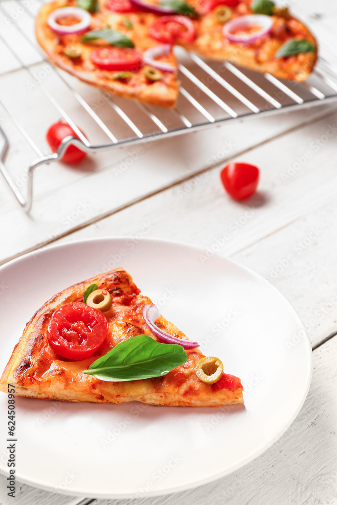 Plate with tasty pizza, ingredients and grid on white wooden background