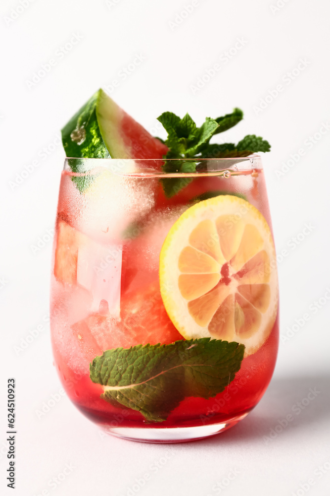 Glass of fresh watermelon lemonade with mint on white background