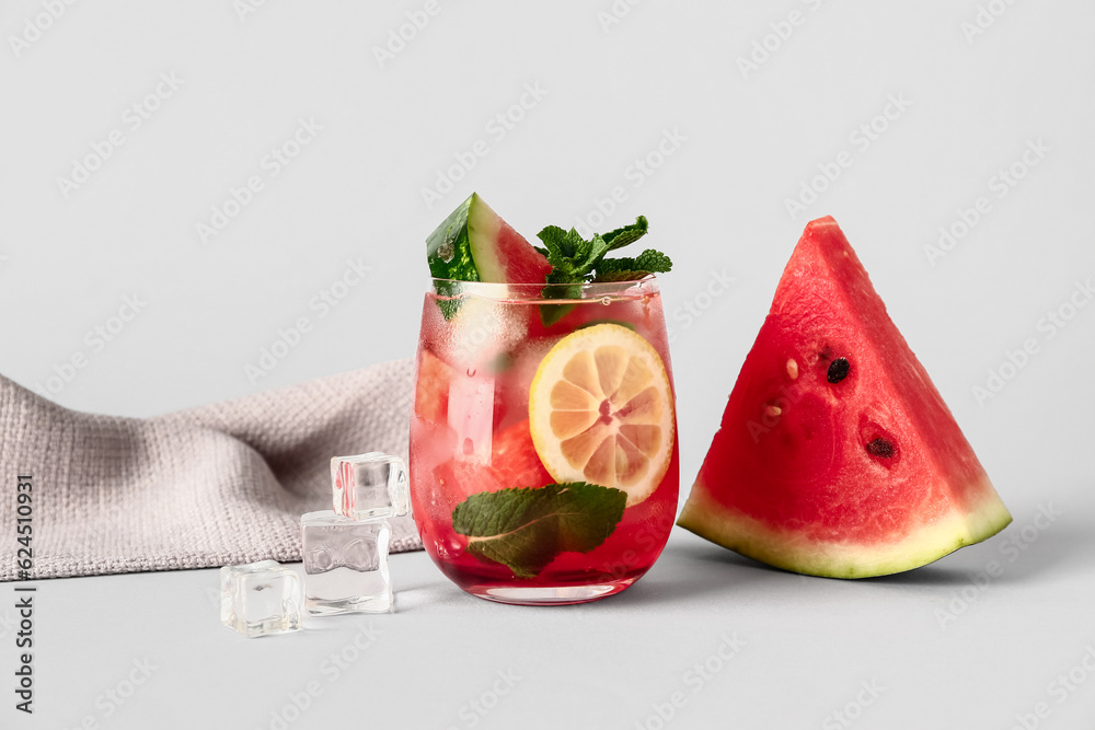 Glass of fresh watermelon lemonade with mint on white background