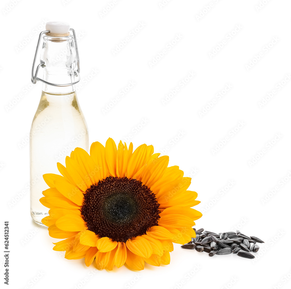 Bottle of oil, sunflower and seeds on white background