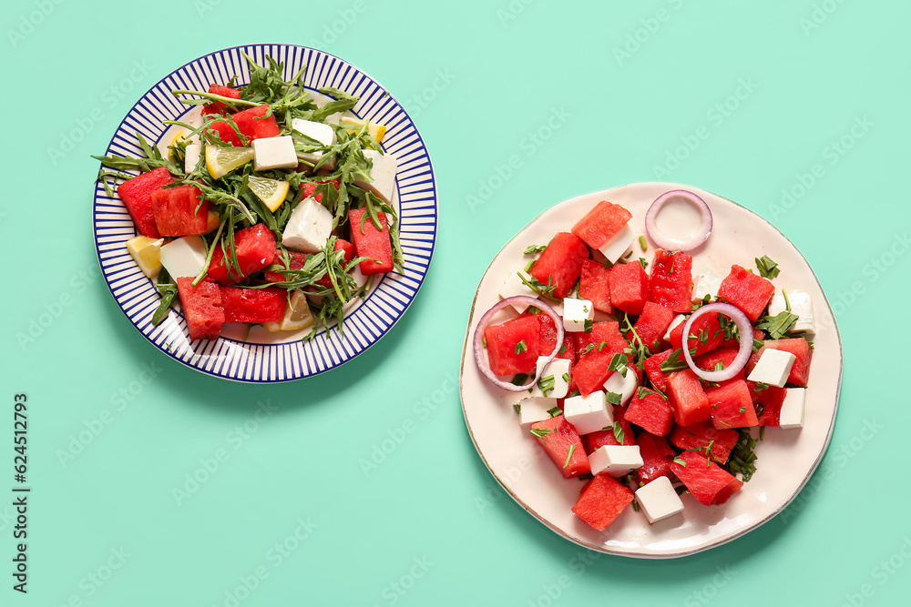 Plates of tasty watermelon salad on turquoise background