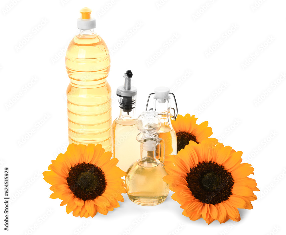 Bottles and decanter with sunflower oil on white background