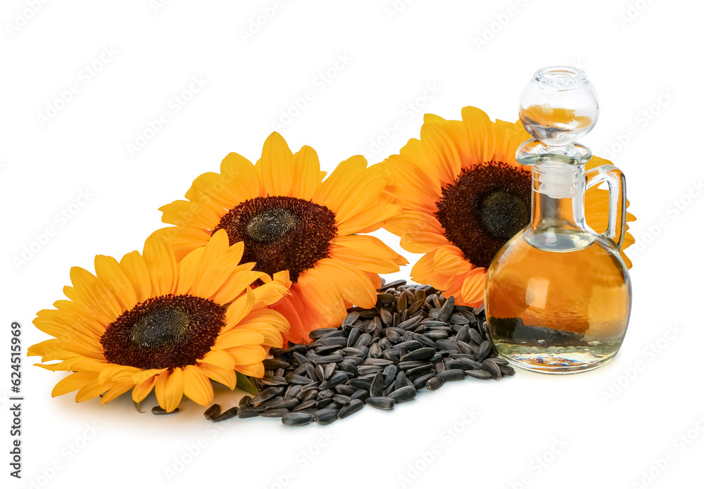 Sunflowers, seeds and decanter with oil on white background