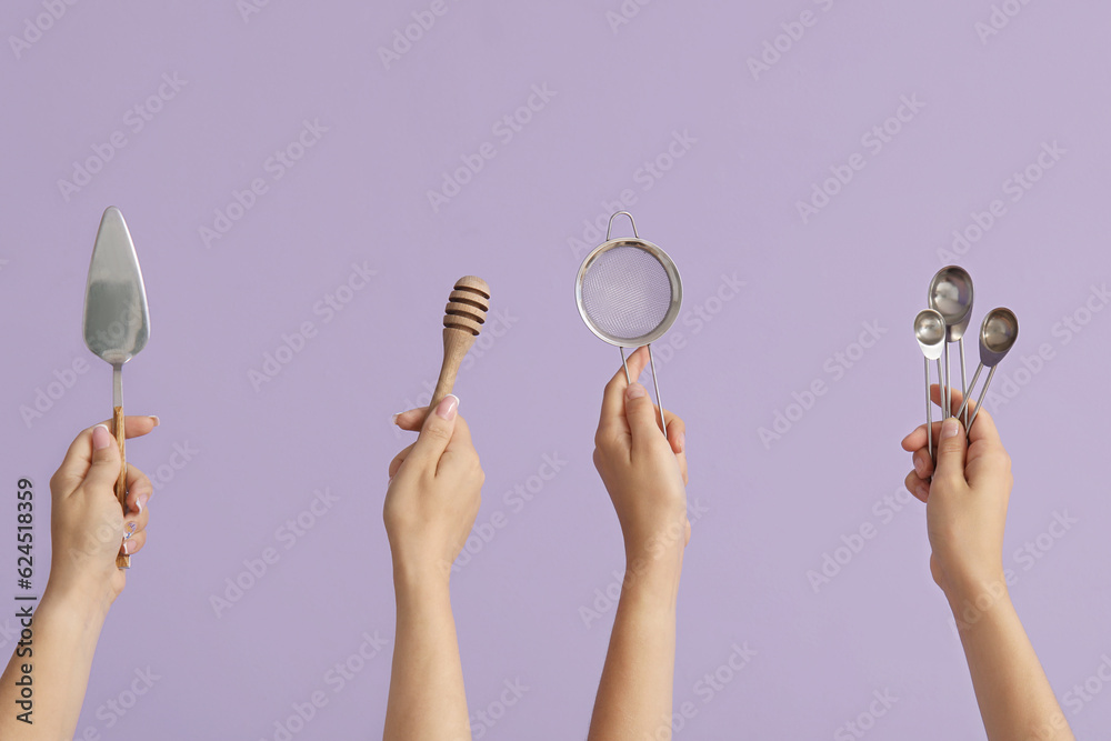 Female hands with baking utensils on lilac background