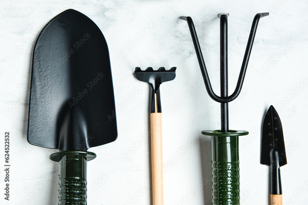 Set of gardening tools on white marble background