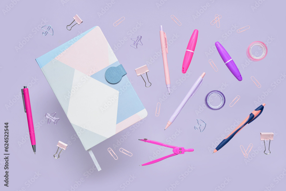 Composition with notebook and stationery on lilac background