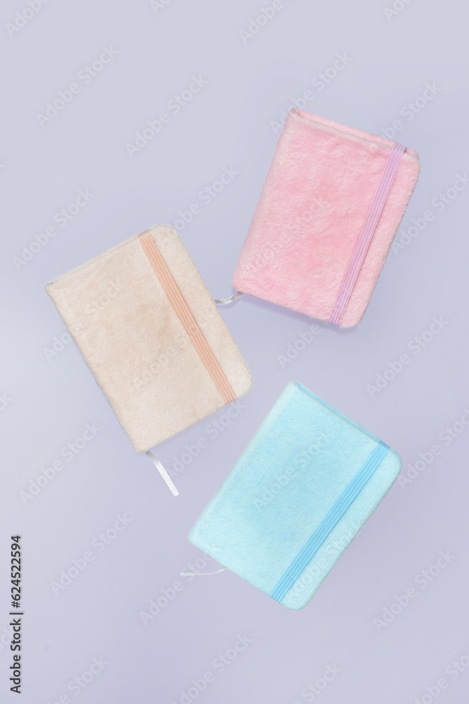 Colorful notebooks on grey background