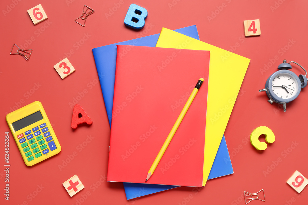 Different school stationery on red background