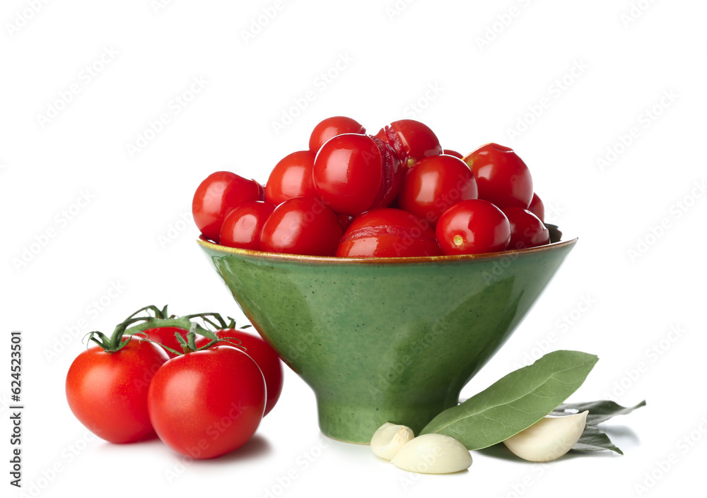 Bowl with canned tomatoes and garlic on white background