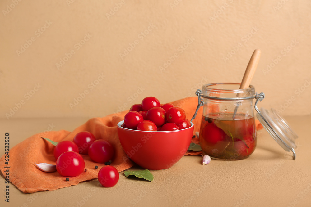 Bowl and jar with canned tomatoes on brown background