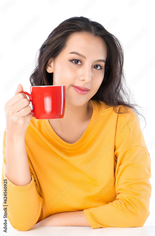 Young Asian woman working on laptop she wearing a yellow sweater shot isolated on white background