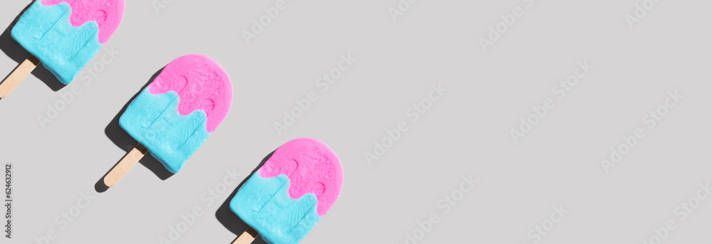 Pink and blue popsicles with shadow - flat lay