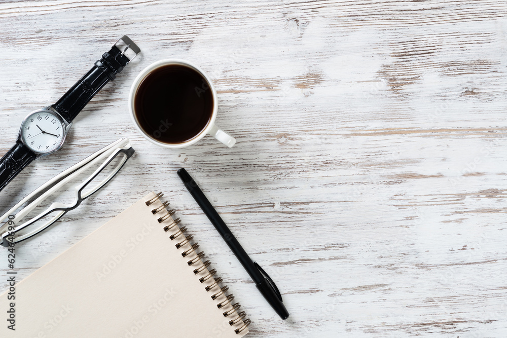 Top view office desk with white cup of coffee