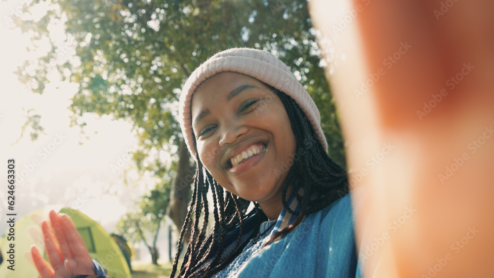 African woman, video call and camping in nature with talk, point and face with tent, forrest and hol