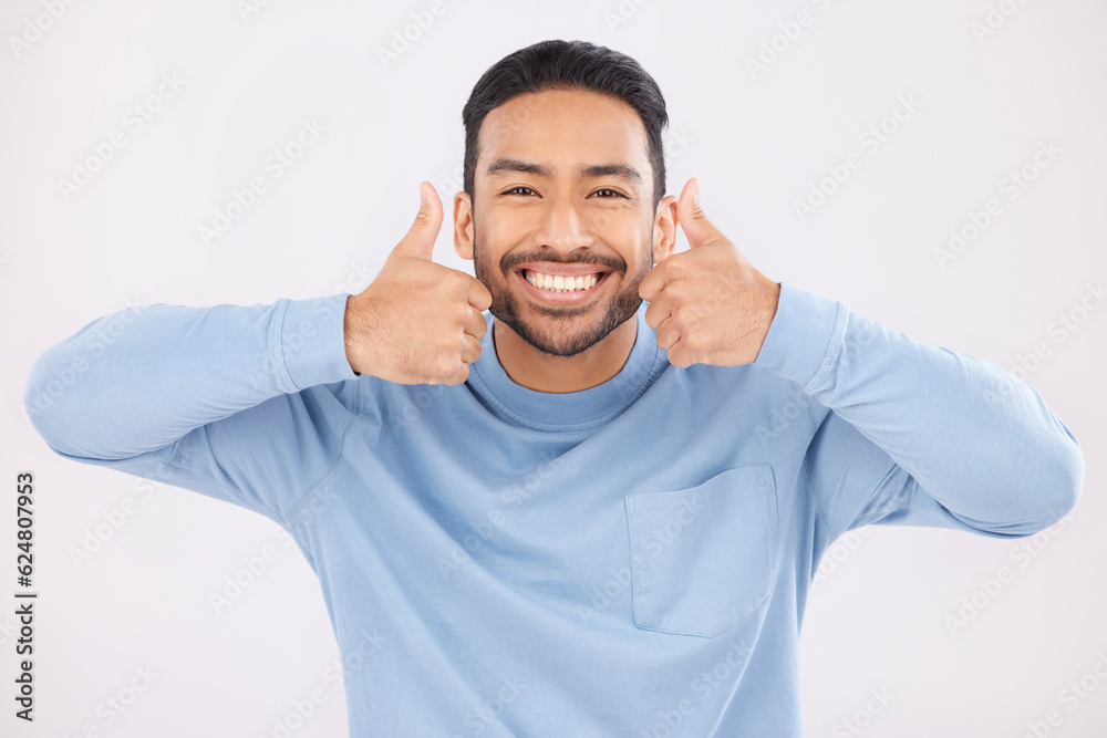 Portrait, thumbs up and man in studio happy with hand, sign and thank you on white background. Smile