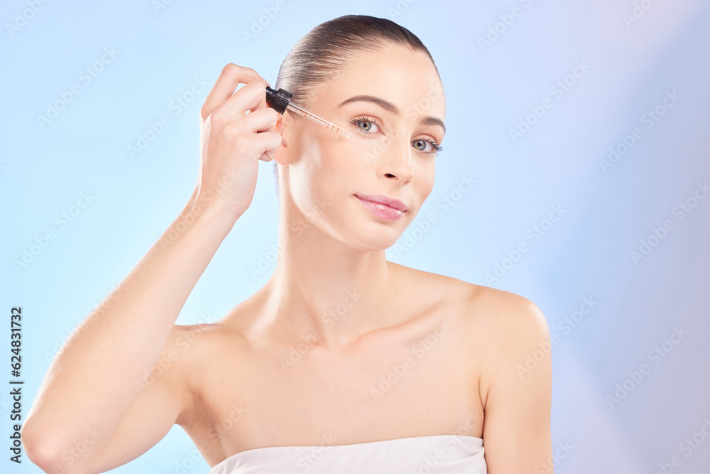 Woman, portrait and serum for face in studio, aesthetic skincare or dermatology on blue background. 