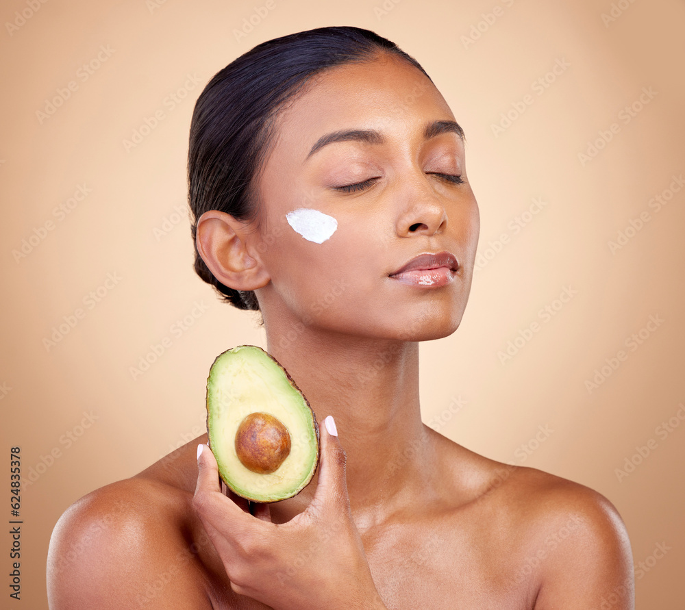 Beauty, cream and skincare with woman and avocado in studio for product, fruit and natural cosmetics