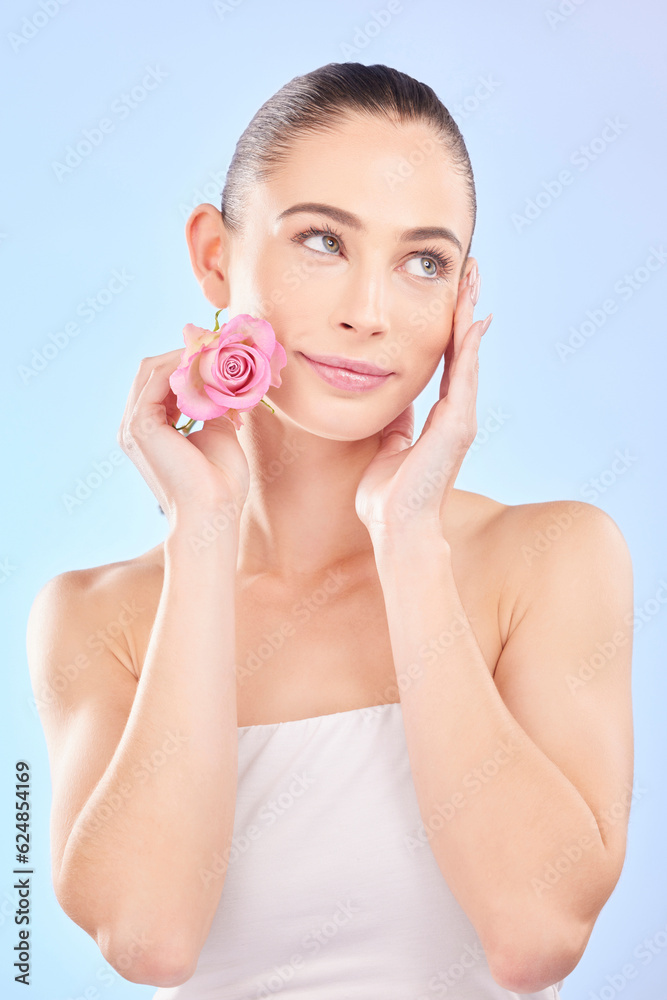 Woman, beauty and rose for skincare in studio, eco plant cosmetics and natural aesthetic on blue bac