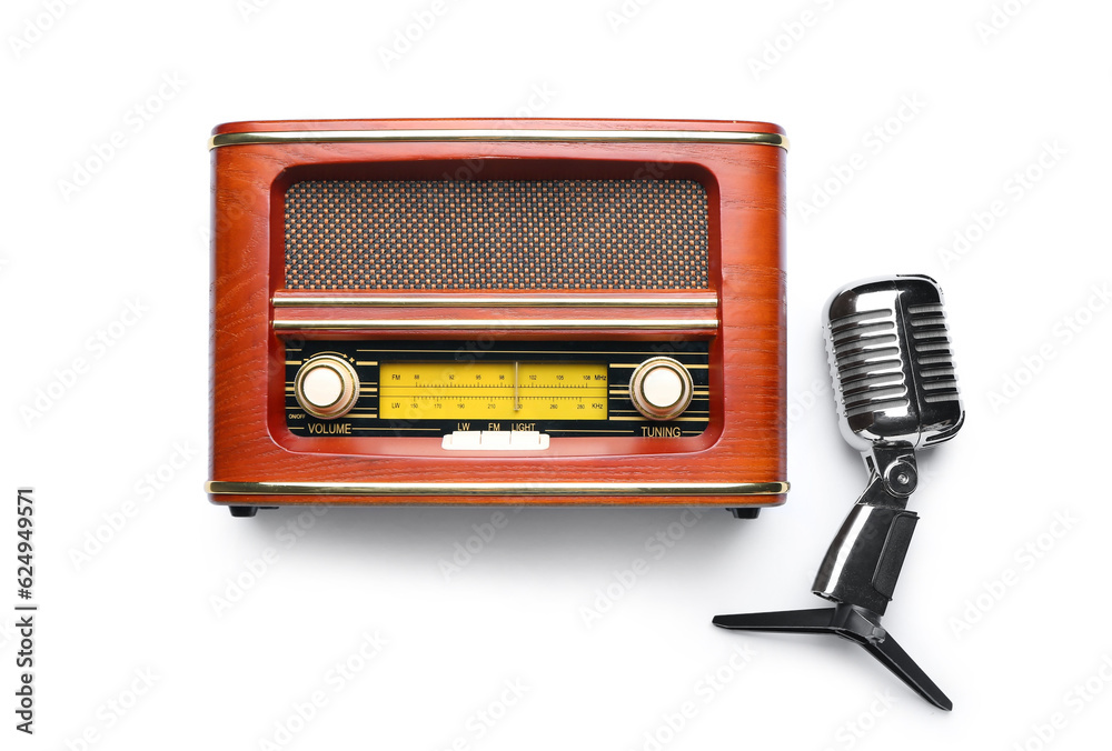 Microphone and retro radio receiver on white background