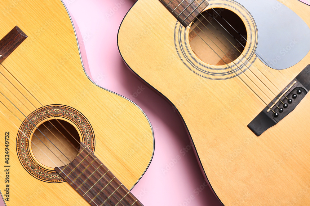 Acoustic guitars on color background, closeup