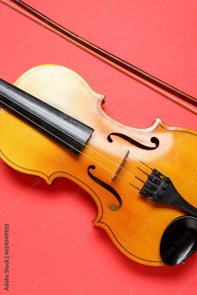 Beautiful violin with bow on color background