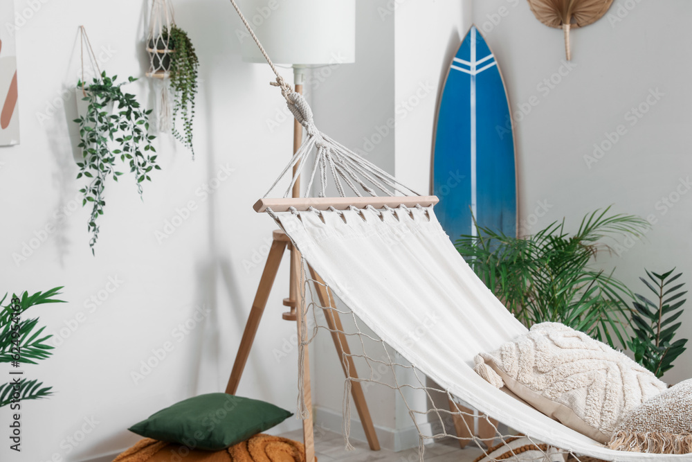 Cozy hammock with cushions in interior of living room