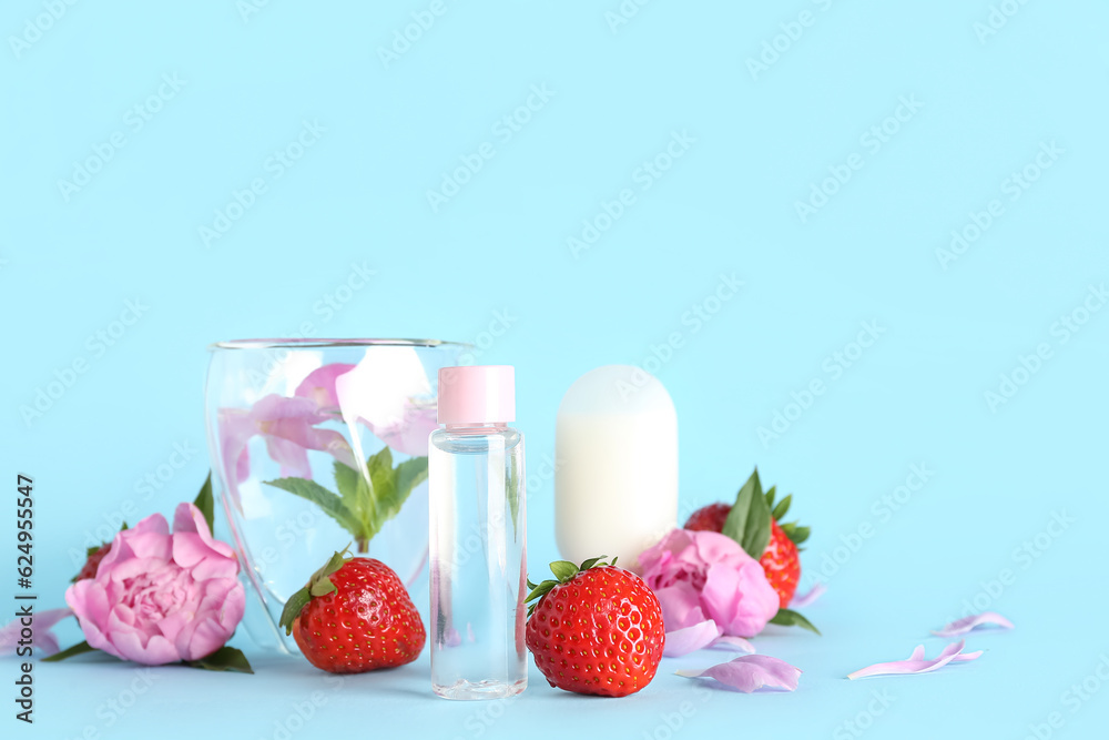 Composition with cosmetic products, glass of water, strawberry and peony flowers on color background