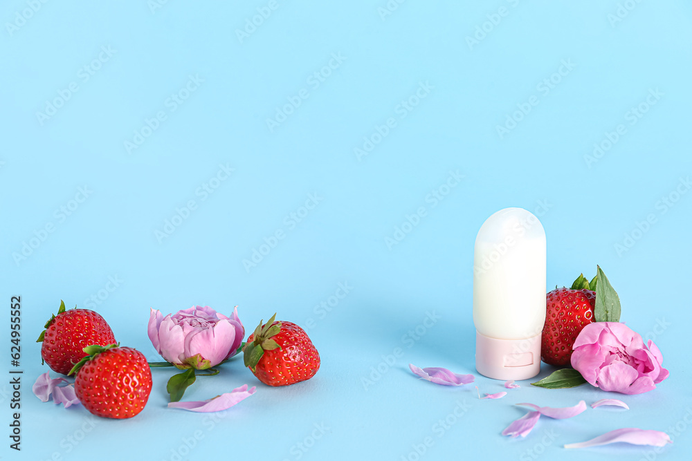 Composition with deodorant, strawberry and peony flowers on color background