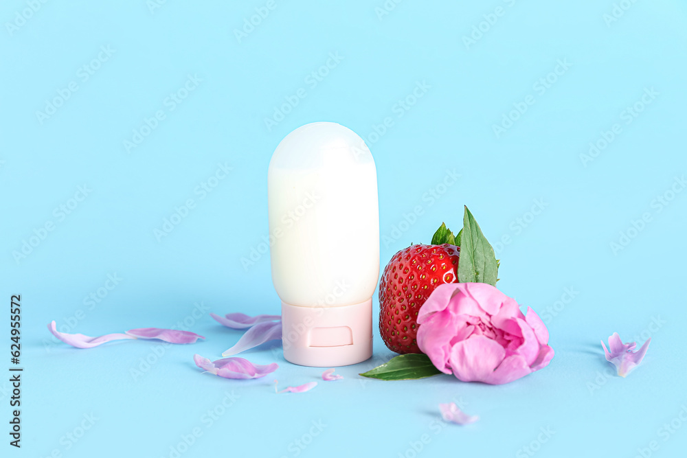 Composition with deodorant, strawberry and peony flower on color background