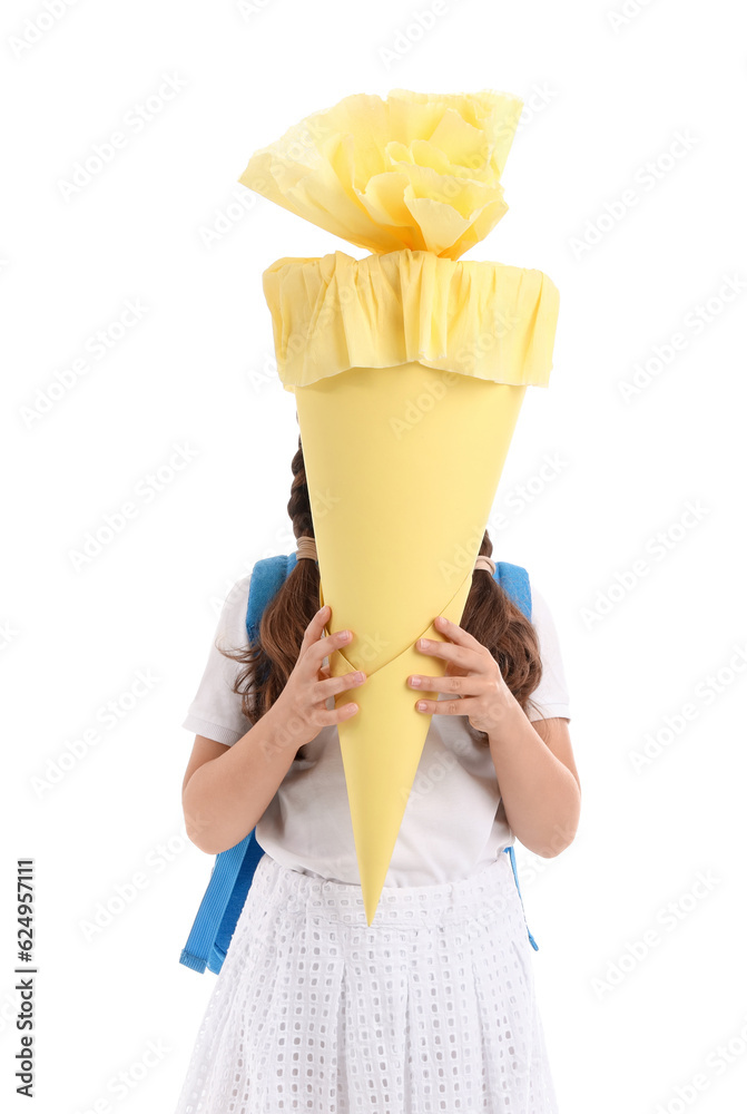 Little girl with backpack and yellow school cone isolated on white background