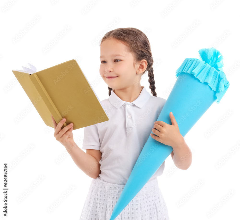 Happy little girl with blue school cone reading book isolated on white background