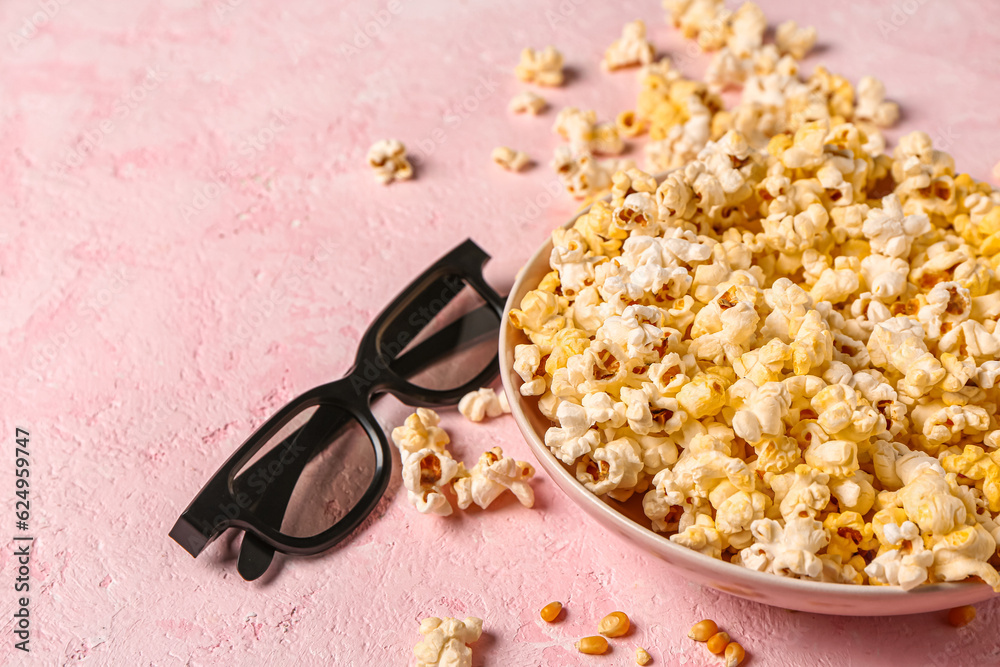 Bowl with tasty popcorn and 3D glasses on pink background