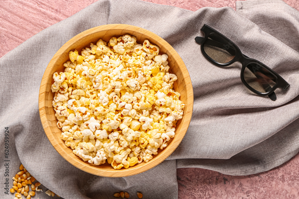 Bowl with tasty popcorn and 3D glasses on pink background